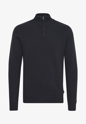 Crni pleteni pulover s visokim ovratnikom i četvrtastim patentnim zatvaračem. Rebrasti manžeti i rub, glatka tekstura i prilagođen dizajn.