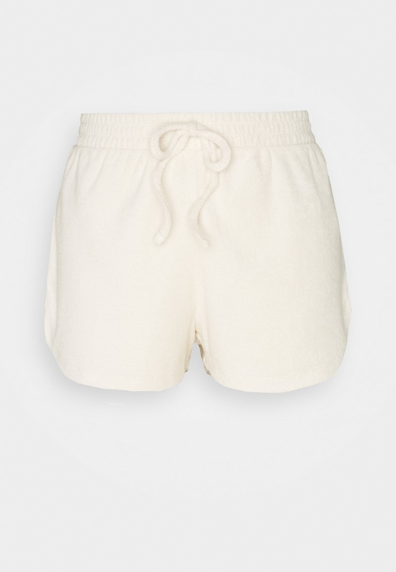 Shorts taille élastique écrus avec cordon de serrage, réalisés en tissu doux, présentés sur un fond uni.