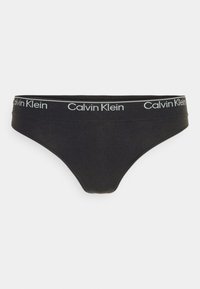 Mustat stringit pehmeällä pinnalla, joissa on leveä vyötärönauha, johon on kirjailtu valkoisilla kirjaimilla "Calvin Klein". Yksinkertainen, minimalistinen muotoilu.