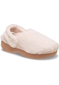 Chausson en fausse fourrure rose doux, avec un bout arrondi, une découpe au talon arrière et une semelle en caoutchouc beige avec un motif de grip texturé.