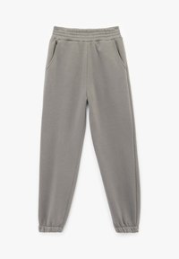 Lysegrå sweatpants lavet af blødt stof, med elastisk talje, sidelommer og ribbede manchetter ved anklerne.