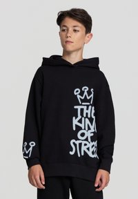 Felpa nera in cotone misto con testo in stile graffiti bianco che recita "IL RE DELLA STRADA" e design di corone sulle maniche.