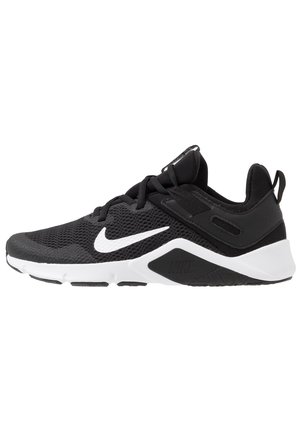 Sneaker atletica nera con suola bianca e logo Nike Swoosh, tomaia in mesh traspirante e design con lacci.