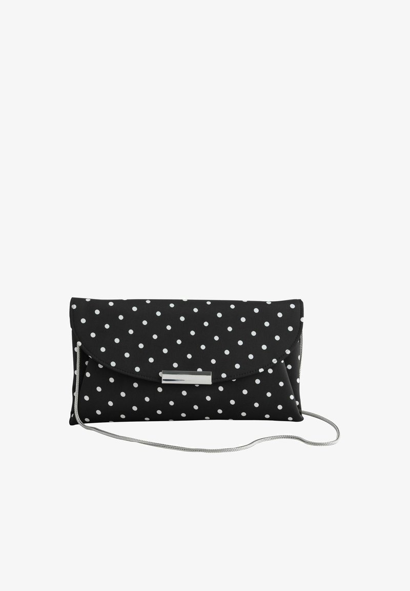Pochette noire à pois blancs, fermoir argenté et fine chaîne d'épaule argentée sur fond blanc uni.