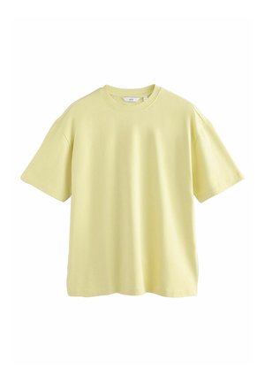 T-shirt à manches courtes et col ras du cou en tissu doux et léger, de couleur jaune pâle. Coupe décontractée et fluide avec une texture lisse.