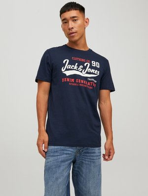 Navy blue cotton t-shirt featuring white and red text, round neck, short sleeves, and relaxed fit. Includes brand name and graphics.