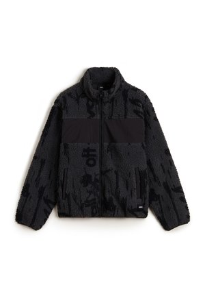 Giacca in fleece nera con finitura testurizzata, caratterizzata da un pannello orizzontale nero a tinta unita e due tasche laterali con zip.