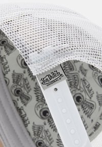 White mesh cap with a decorative graphic interior, featuring a logo tag and a solid white adjustable strap. Circular ventilation details visible.