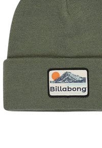 Olive green knit beanie with a folded cuff. Features a rectangular logo patch with a mountain and sun illustration and "Billabong" text.