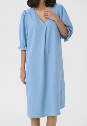 Abito azzurro chiaro, lunghezza al ginocchio, in tessuto strutturato. Presenta una scollatura a V e maniche corte a sbuffo con volant elasticizzati. Vestibilità semplice e ampia.