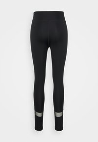 Svarta leggings gjorda av stretchigt material, med en bred midjeresår och genomskinliga paneler vid anklarna. Slät textur, hel längd.