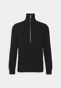 Maglione nero a costine con colletto alto e dettagli con mezza cerniera sul davanti. Il materiale sembra morbido e testurizzato, con maniche lunghe.