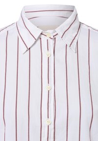 Weißes Hemd mit schmalen roten vertikalen Streifen. Verfügt über einen klassischen Kragen und drei beigefarbene Knöpfe entlang der Knopfleiste. Glatte Textur.