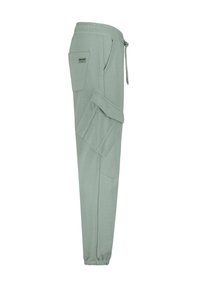 Helle grüne Jogginghosen aus weichem Stoff, ausgestattet mit einem elastischen Bund mit Kordelzug, Seitentaschen und einer Reißverschlusstasche.