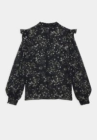Blouse noire à motifs floraux en tissu léger. Présente des épaules élastiques, de longues manches bouffantes avec des poignets élastiques, et un col haut.