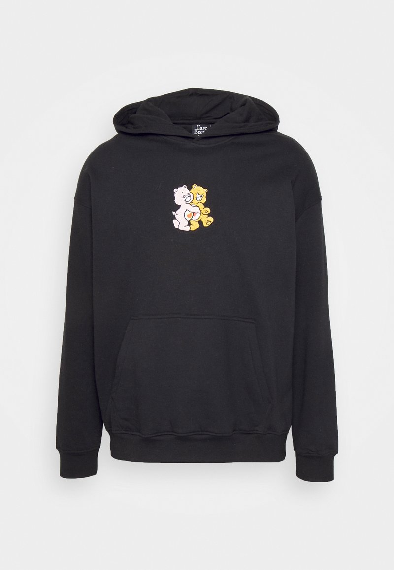 Sweat à capuche noir avec poche avant, représentant un petit motif de deux Care Bears s'étreignant, un blanc et un jaune, centré sur la poitrine.