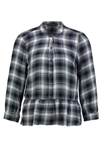 Chemise à carreaux noire, blanche et grise. Dotée d'une finition peplum et de longues manches avec poignets boutonnés. Tissu léger et respirant.
