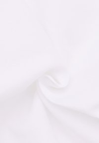 Tessuto bianco con una texture liscia e morbida, leggermente stropicciato, che mostra un aspetto drappeggiato e una leggera lucentezza.