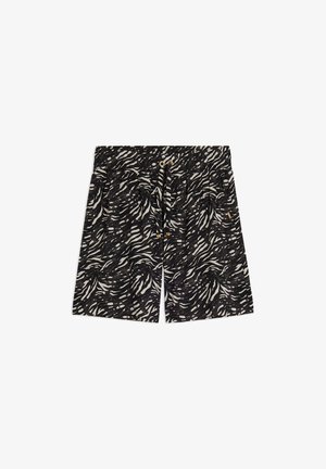 Pantalones cortos en blanco y negro con un diseño ondulado, cintura elástica con cordón y dos bolsillos laterales. Tela ligera.