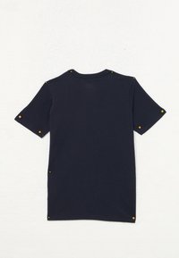 Dark navy short-sleeve t-shirt with a crew neck. Features gold-colored snaps at shoulder seams and side hems. Cotton material with smooth texture.