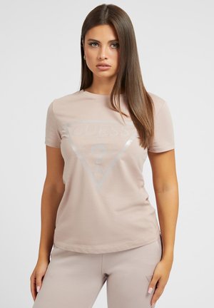 Light pink cotton t-shirt with a crew neckline featuring a glossy triangular "GUESS" logo and a question mark design in the center.