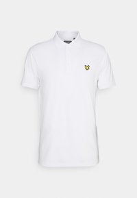 Valkoinen lyhythihainen polo paita, jossa on kolme nappia ja pieni keltainen lintulogo vasemmassa rinnassa.