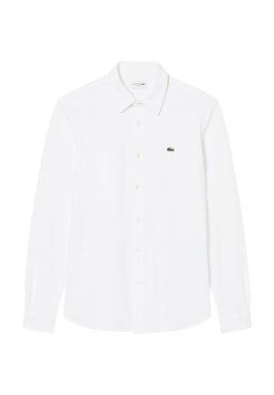 White long-sleeve button-up shirt made of cotton. Features a classic collar and small green Lacoste logo on the left chest.