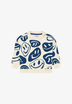 Kremowa bluza z wzorem niebieskich uśmiechniętych twarzy, okrągłym dekoltem, długimi rękawami oraz prążkowanymi mankietami i dołem.