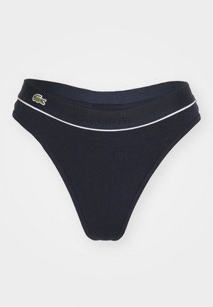 Námorné bikiny s rebrovým vzorom, biele akcentové pásky a embosovaný logo "LACOSTE". Na boku sa nachádza malý zelený krokodíl logo.