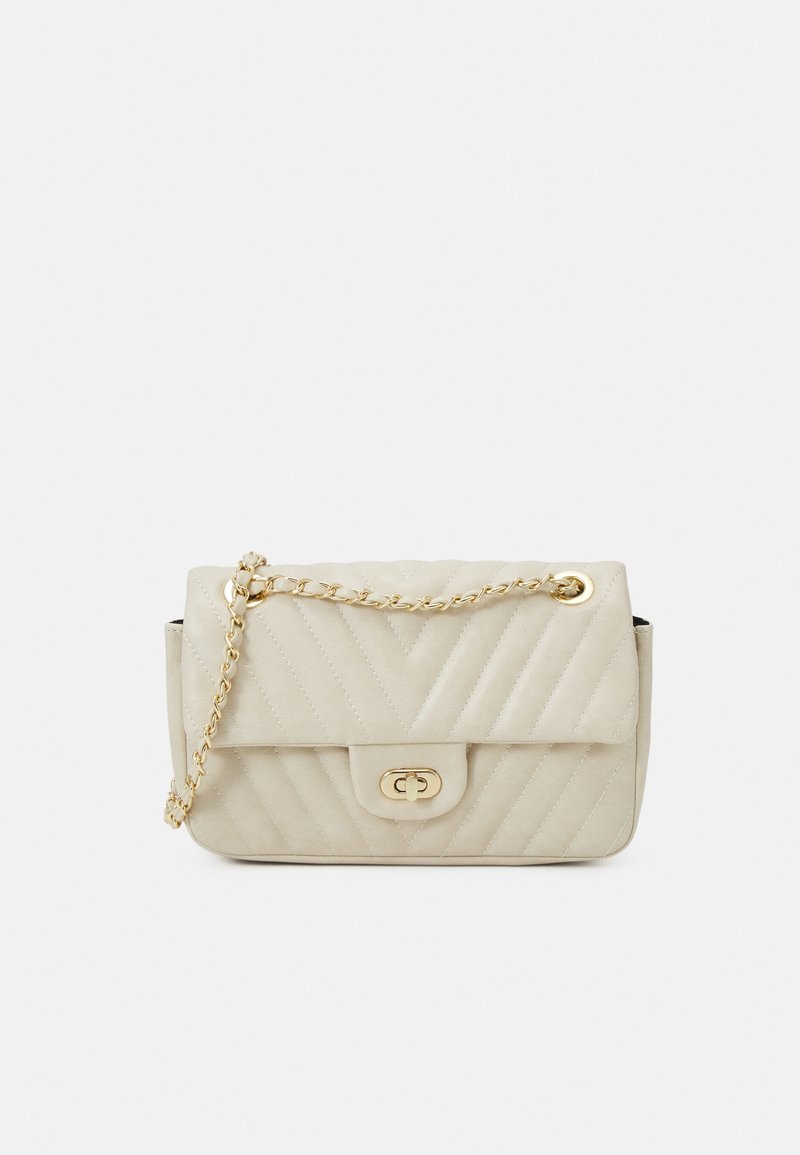 Beige quilted bag with gold chain strap, featuring a flap closure and decorative hardware. Rectangular shape with smooth texture.