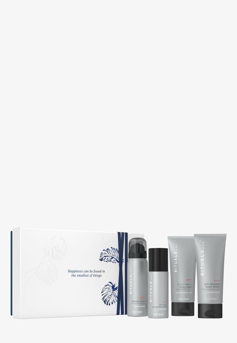 Zestaw czterech produktów do pielęgnacji skóry w szarych opakowaniach, w tym pianka pod prysznic, dezodorant i balsam do ciała, zaprezentowany w białym pudełku z niebieskimi akcentami.