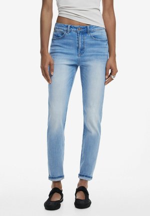Light blue denim jeans with a slim fit, featuring a mid-rise waist, rolled cuffs, five-pocket design, and subtle fading.