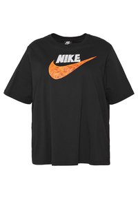 Černé bavlněné tričko s pohodlným střihem, které má na přední straně bílé logo "NIKE" a oranžový grafický pruh. Krátké rukávy.