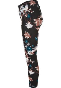 Leggings noirs ornés d'un motif floral avec des accents blancs, marron et bleus. Le design comprend un tissu lisse et une silhouette ajustée.