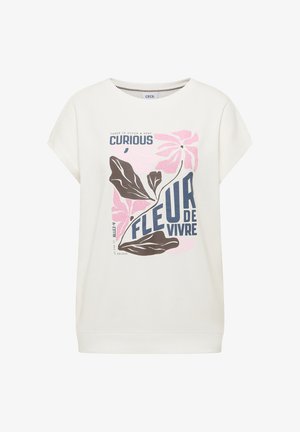 White short-sleeve shirt with pink flowers, brown leaves, and blue text reading "Curious Fleur de Vivre" on the front.