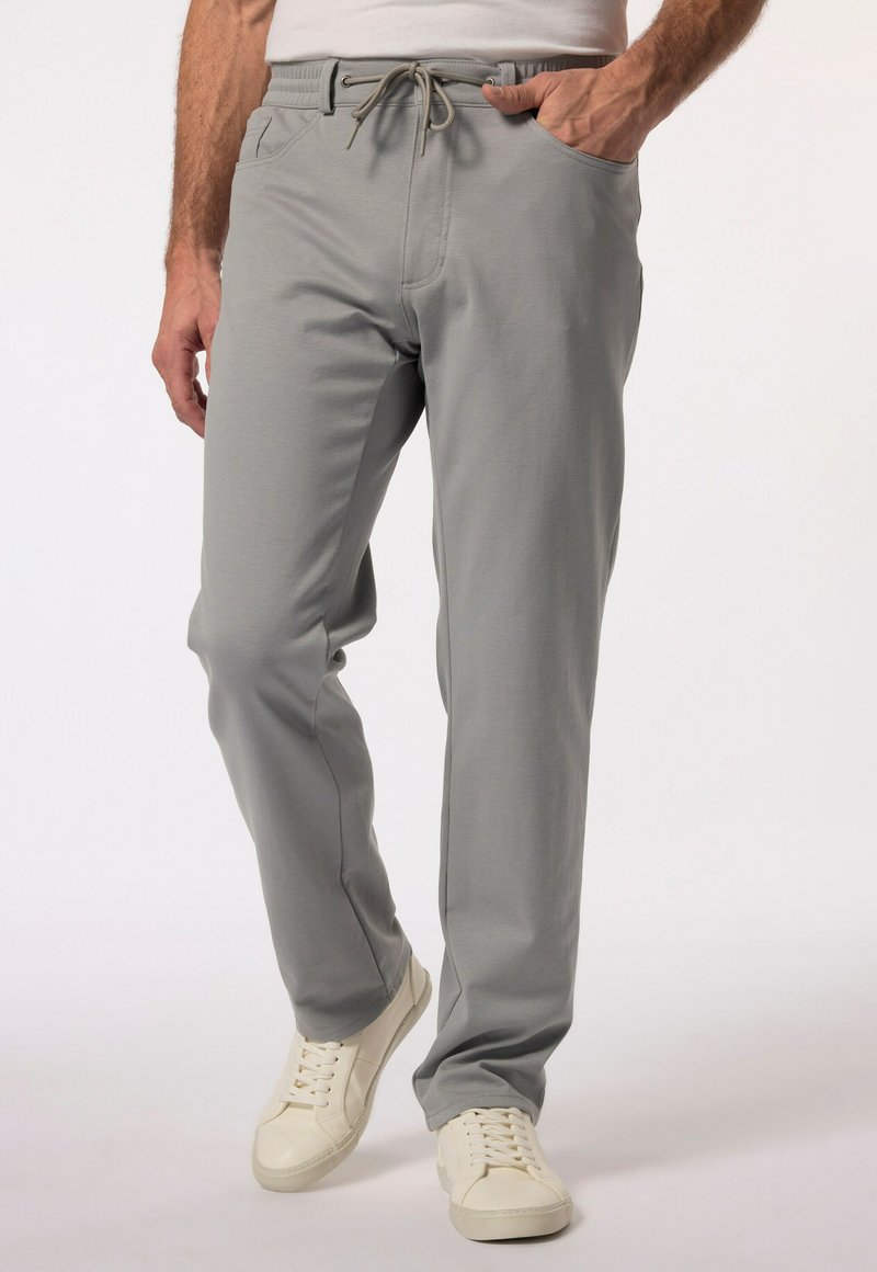 Ljusgrå joggers gjorda av mjuk väv, med elastisk midja och dragsko, framfickor och en tapered design.