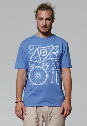 Lichtblauwe katoenen T-shirt met witte grafische ontwerpen van fietscomponenten, waaronder tandwielen, gereedschap en een wiel, op de voorkant.