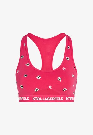 Rozā sporta krūšturis ar racerback dizainu, ar maziem logo printiem un baltu zīmola joslu, uz kuras rakstīts "KARL LAGERFELD". Gluda auduma tekstūra.