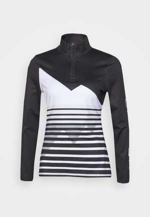 Haut de sport à manches longues en noir et blanc. Il présente un col avec demi-fermeture éclair, un motif en zigzag et des rayures horizontales sur la partie inférieure.