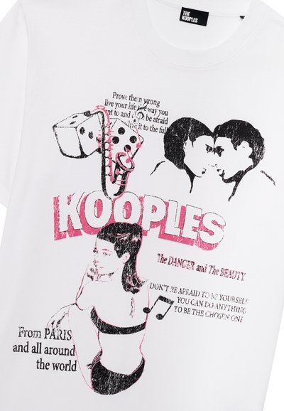 White cotton t-shirt featuring bold black and pink graphic prints, including text and illustrations of dice and figures.