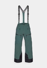 Calças de ski verdes com detalhes em preto, alças ajustáveis pretas, múltiplos bolsos com zíper e um corte solto para maior mobilidade.