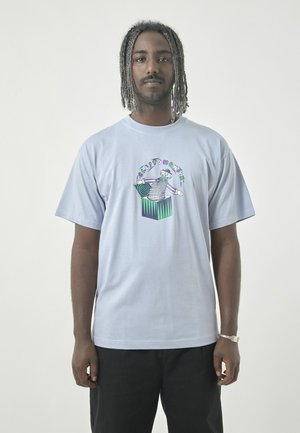 Light blue short-sleeve t-shirt featuring a graphic design with a colorful cartoon figure and a striped pattern in the center.