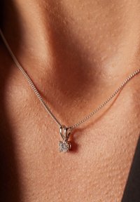 Zilveren ketting met een vierkant, helder edelsteen hanger, met een slank ontwerp en een gepolijste afwerking. Zichtbare schakels en sluiting.