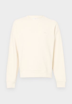 Light beige sweatshirt made of textured fabric, featuring a round neck, long sleeves, and a subtle logo on the chest.