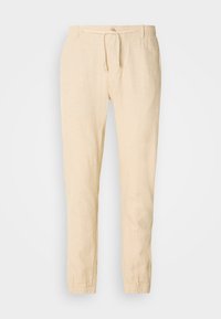 Linnen broek in lichtbeige met een trekkoord taille, tapered leg ontwerp en elastische manchetten. Gladde textuur met subtiele stikseldetails.