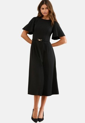 Rochie midi neagră cu mâneci flutter, guler rotund, talie strânsă accentuată de o cataramă de ton auriu și țesătură moale, netedă.