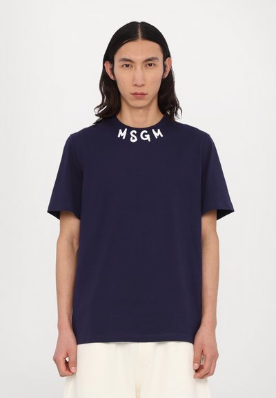 Navy blue cotton t-shirt with short sleeves and a round neckline. Features white lettering "MSGM" embroidered at the collar.
