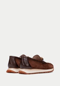 Mocassini in suede marrone con dettagli in rilievo a pelle di coccodrillo, punta arrotondata e suola in gomma con finitura testurizzata. Logo impresso sulla suola.