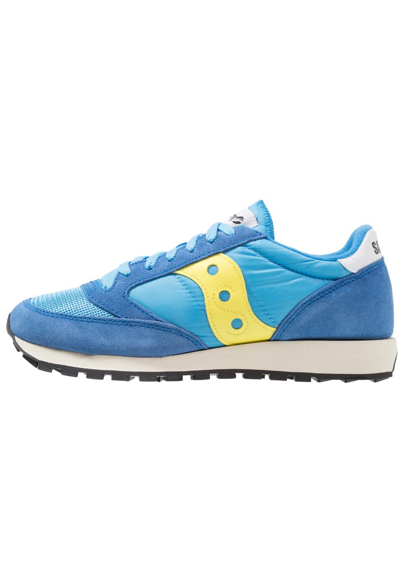 Blue and light blue athletic shoe with suede and nylon materials, yellow accents, round perforations, and a white logo on the heel.