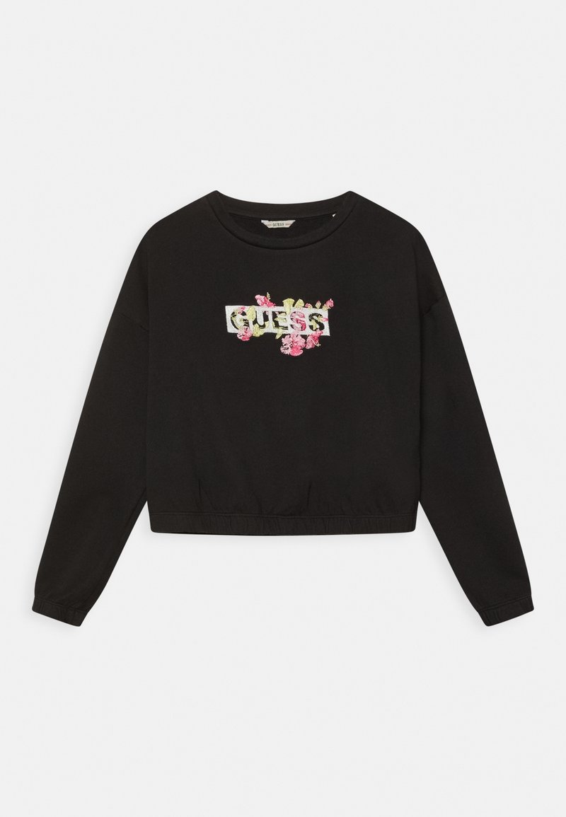 Sweat-shirt noir à manches longues avec col rond, ourlet élastique et logo "GUESS" blanc entouré d'une broderie florale rose et verte.